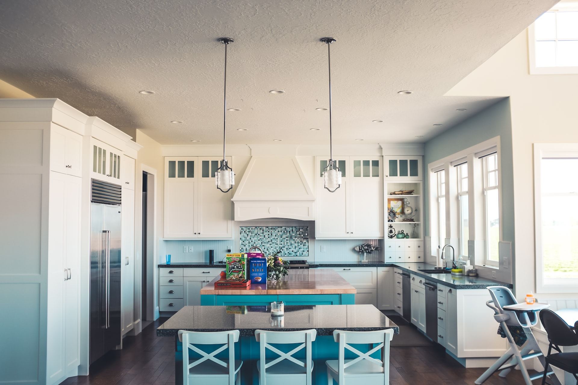 Bright kitchen with recessed and pendant lighting